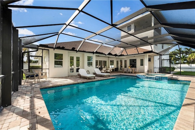 view of swimming pool featuring glass enclosure, a patio area, an in ground hot tub, and french doors