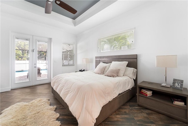 bedroom featuring french doors, ornamental molding, access to outside, a tray ceiling, and ceiling fan