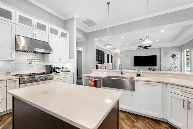 kitchen with pendant lighting, ceiling fan, white cabinets, and tasteful backsplash