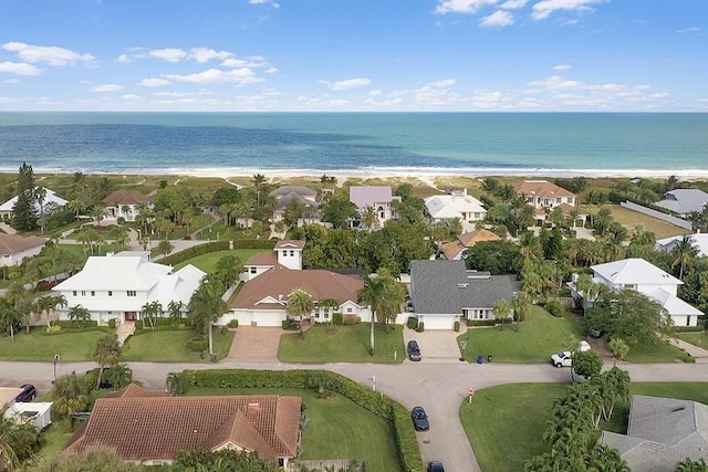 drone / aerial view with a water view and a view of the beach