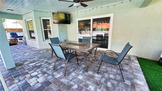 view of patio featuring outdoor dining space and ceiling fan