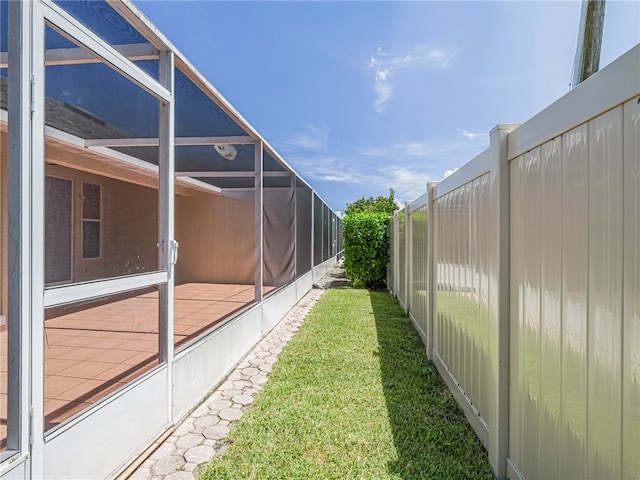 view of yard featuring glass enclosure