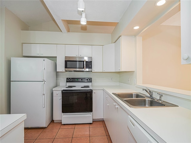 kitchen with white cabinets, white appliances, light tile patterned floors, and sink