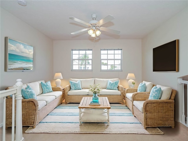 carpeted living room with ceiling fan