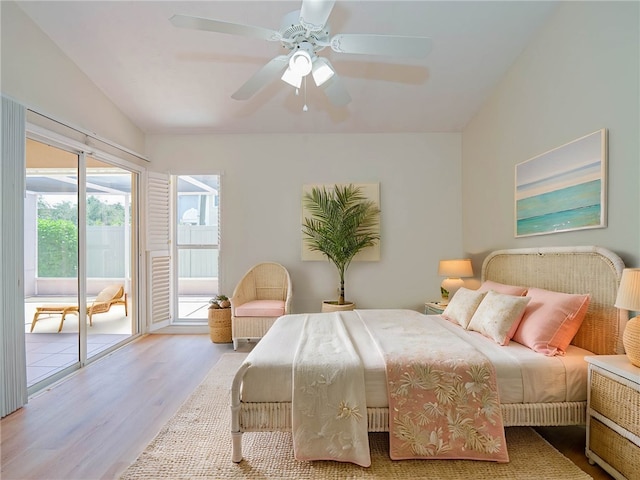 bedroom featuring access to outside, lofted ceiling, ceiling fan, and light hardwood / wood-style floors