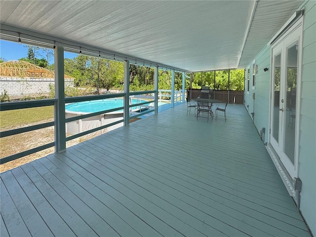 10320 92nd St, Vero Beach, FL 32967 - wooden terrace with outdoor dining area, fence, and a fenced in pool