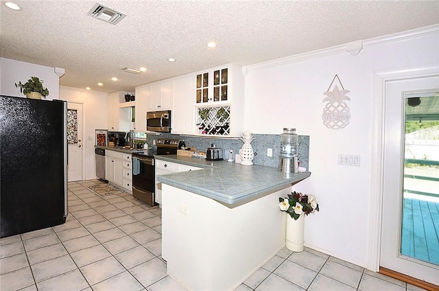 10320 92nd St, Vero Beach, FL 32967 - kitchen featuring light tile patterned floors, white cabinetry, open shelves, tasteful backsplash, and appliances with stainless steel finishes