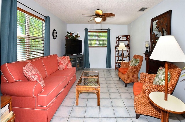 10320 92nd St, Vero Beach, FL 32967 - tiled living room with plenty of natural light, visible vents, a ceiling fan, and a textured ceiling