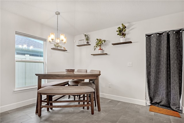 dining space featuring a notable chandelier