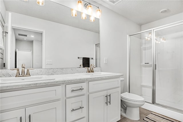 bathroom featuring walk in shower, tile patterned floors, a textured ceiling, toilet, and vanity