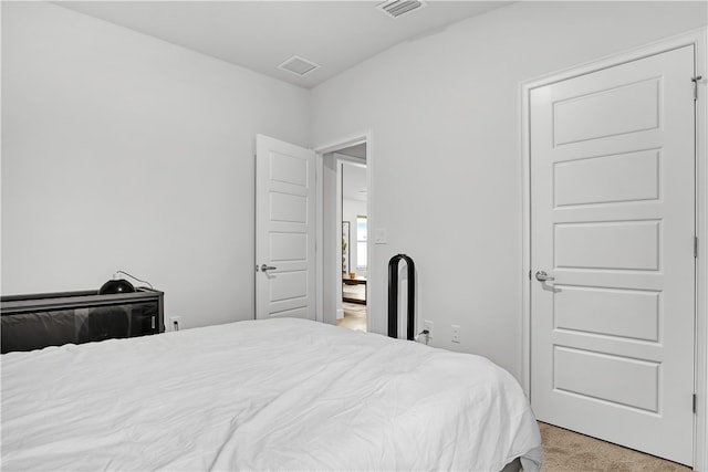 bedroom with light colored carpet