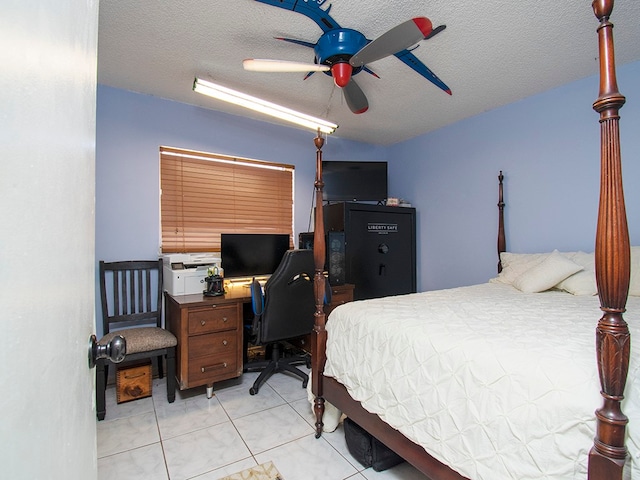 tiled bedroom featuring ceiling fan and a textured ceiling