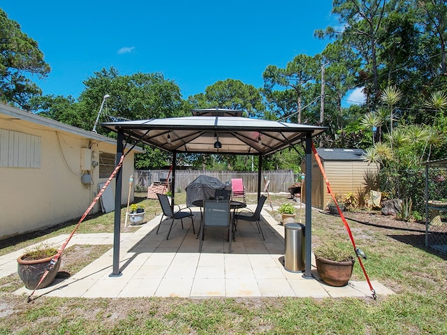 view of patio / terrace with a storage unit and a gazebo