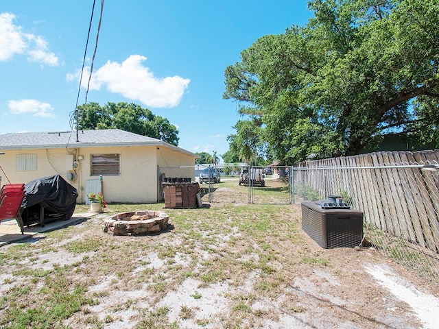 view of yard with an outdoor fire pit