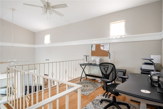 office area with ceiling fan, hardwood / wood-style floors, and vaulted ceiling