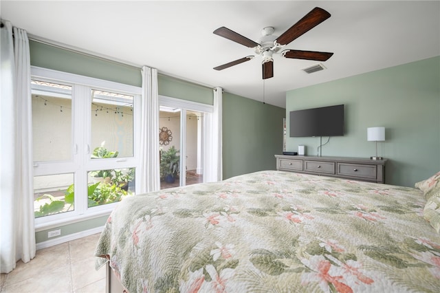 tiled bedroom with access to outside and ceiling fan