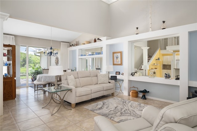 tiled living room featuring high vaulted ceiling and an inviting chandelier