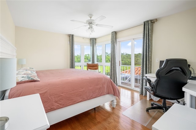 bedroom featuring ceiling fan, wood-type flooring, and access to outside