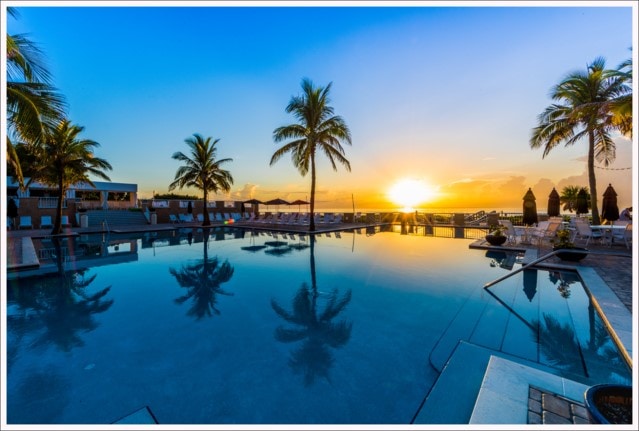 pool at dusk featuring a water view