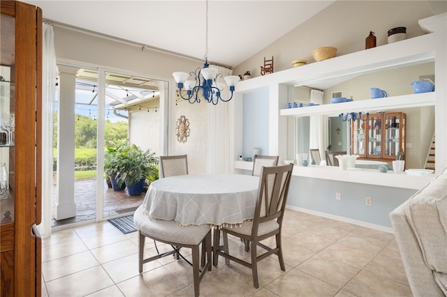 dining area featuring an inviting chandelier, light tile patterned floors, and vaulted ceiling