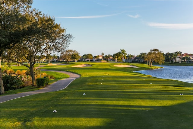 surrounding community with a lawn and a water view