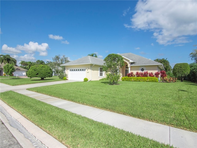 ranch-style home with a garage and a front lawn