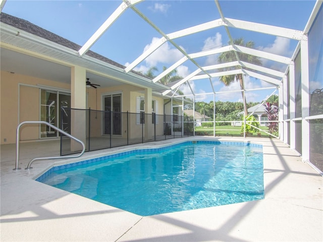 view of pool featuring a patio, ceiling fan, and glass enclosure