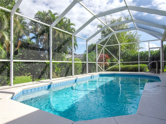 view of pool with glass enclosure