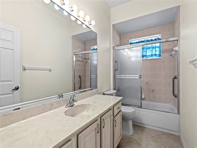 full bathroom with toilet, combined bath / shower with glass door, vanity, and tile patterned floors