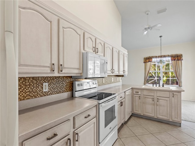 kitchen featuring decorative backsplash, sink, light tile patterned flooring, white appliances, and decorative light fixtures