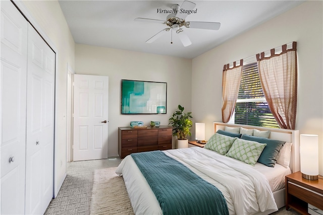 carpeted bedroom featuring ceiling fan and a closet