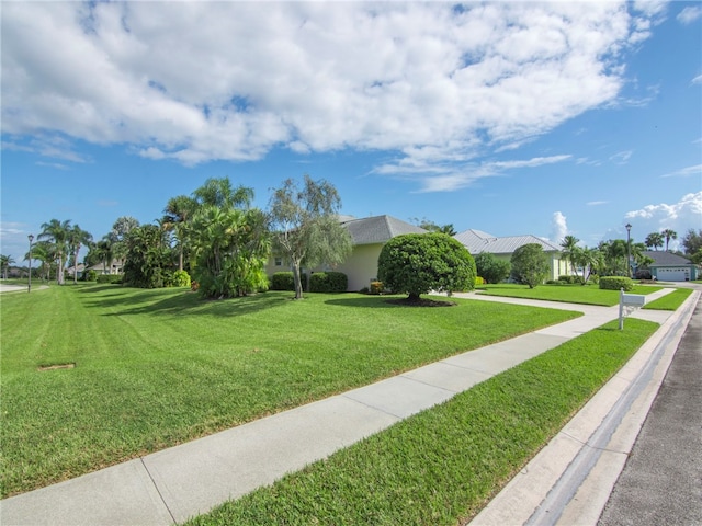 view of property's community with a yard