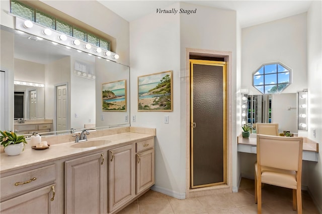 bathroom featuring walk in shower, vanity, and tile patterned floors