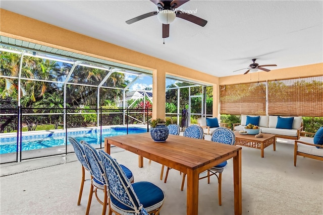 sunroom featuring a swimming pool and ceiling fan