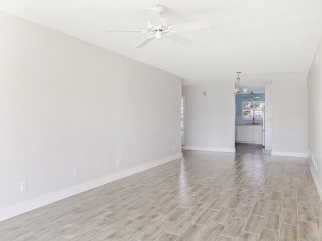 unfurnished living room featuring ceiling fan and light wood-type flooring