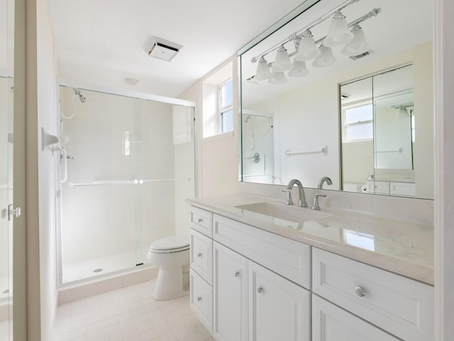 bathroom featuring tile patterned flooring, a healthy amount of sunlight, toilet, and a shower with shower door