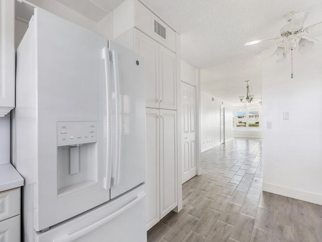 corridor featuring light hardwood / wood-style flooring and a notable chandelier