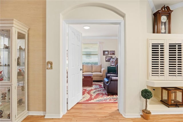 corridor with crown molding and hardwood / wood-style floors