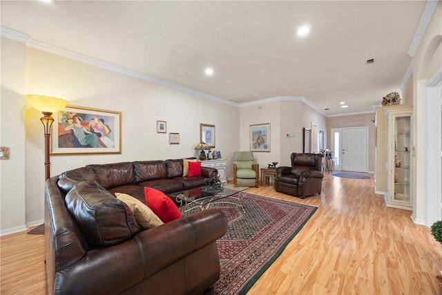 living room featuring light hardwood / wood-style floors and crown molding