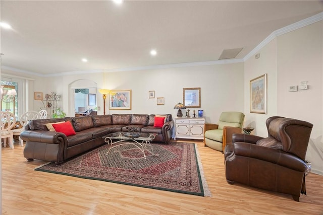 living room with crown molding and light hardwood / wood-style floors