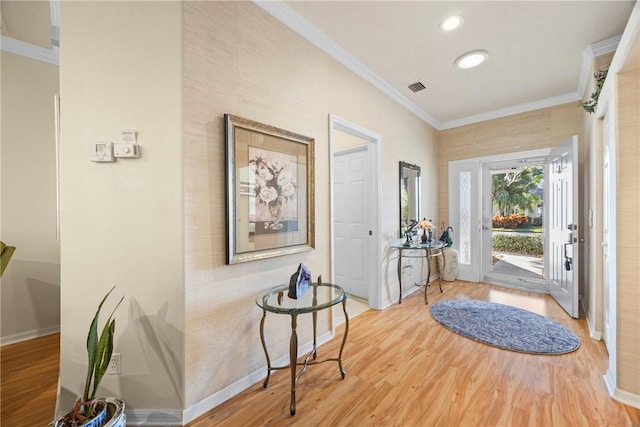 foyer entrance featuring hardwood / wood-style flooring and crown molding