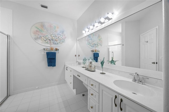 bathroom with tile patterned flooring, vanity, and a shower with door