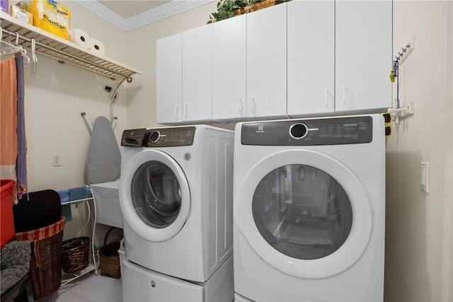 laundry area with cabinets, independent washer and dryer, ornamental molding, and light tile patterned flooring