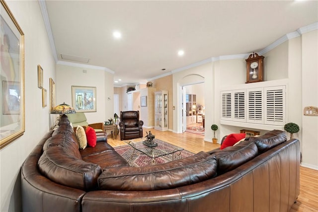 living room featuring crown molding and light hardwood / wood-style flooring