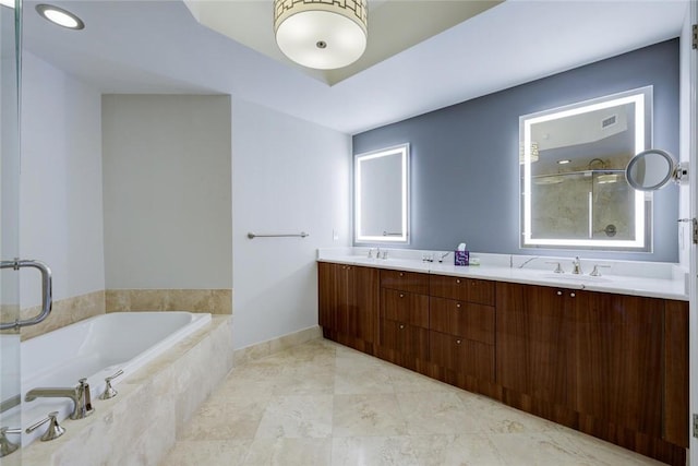 full bathroom featuring a bath, a shower with shower door, and double vanity