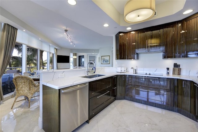 kitchen with stainless steel dishwasher, a sink, a peninsula, light stone counters, and dark brown cabinetry