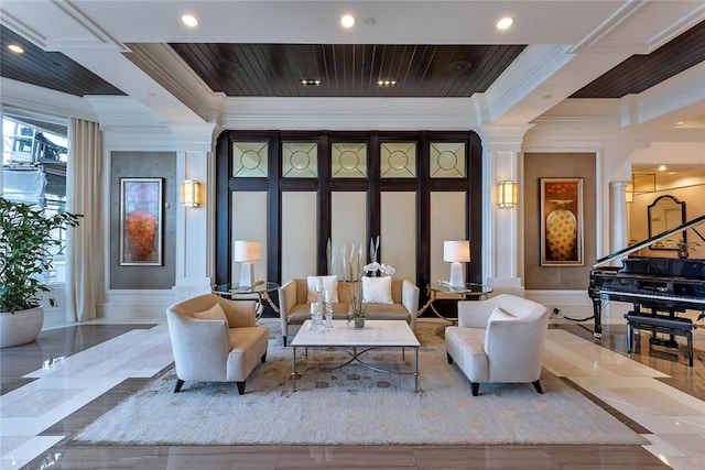 sitting room with ornamental molding, a decorative wall, decorative columns, and recessed lighting