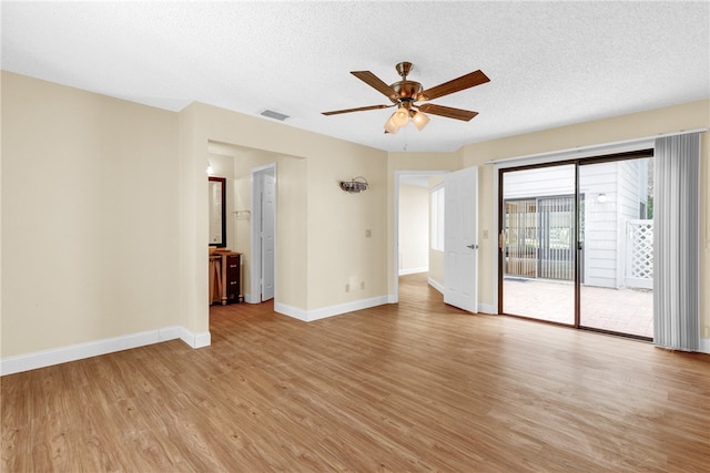 unfurnished room with light hardwood / wood-style floors, a textured ceiling, and ceiling fan