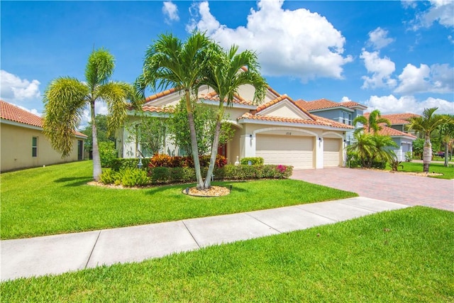 1712 Berkshire Cir SW, Vero Beach, FL 32968 - mediterranean / spanish-style house featuring a garage, decorative driveway, a front lawn, a tiled roof, and stucco siding