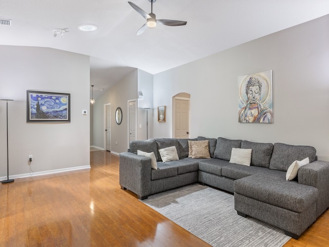 living room featuring hardwood / wood-style floors, ceiling fan, and vaulted ceiling